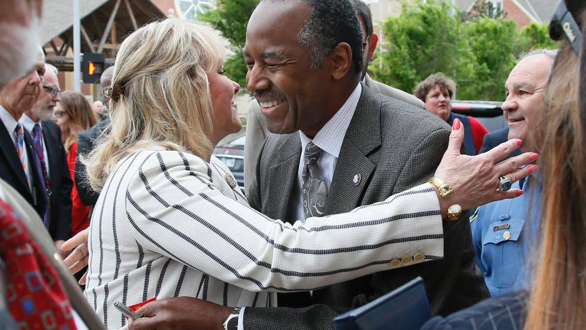 Oklahoma Gov. Mary Fallin, left, greets Housing and Urban Development Ben Carson, M.D., right, before the start of the 22nd Anniversary Remembrance Ceremony of the Oklahoma City bombing in Oklahoma City, Wednesday, April 19, 2017. Carson is speaking at the ceremony. (AP Photo/Sue Ogrocki)