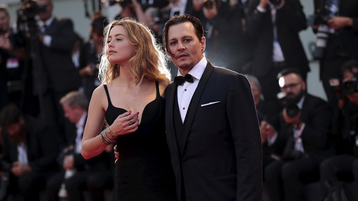 Actor Johnny Depp and his wife Amber Heard attend the red carpet event for the movie "Black Mass" at the 72nd Venice Film Festival in northern Italy September 4, 2015. REUTERS/Manuel Silvestri - RTX1R5ID