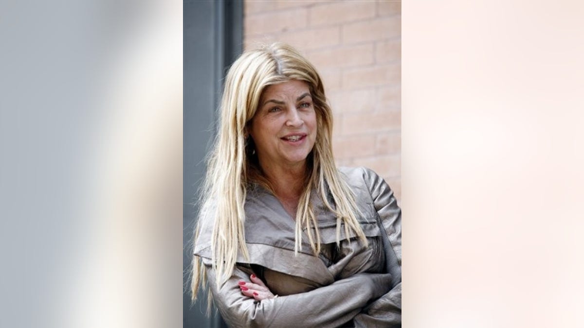 Actress Kirstie Alley talks to the media as she arrives at a building next to the house on Franklin St. in the Tribeca neighborhood of Manhattan where International Monetary Fund leader Dominique Strauss-Kahn is staying under house arrest Saturday, May 28,  2011.  (AP Photo/David Karp)