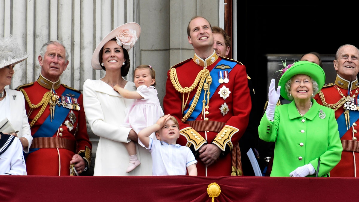 Members of the royal family, including Camilla Duchess of Cornwall, Prince Charles, Catherine, Duchess of Cambridge holding Princess Charlotte, Prince George, Prince William, Queen Elizabeth, and Prince Philip watch a flypast as they stand on the balcony of Buckingham Palace after the annual Trooping the Colour ceremony on Horseguards Parade in central London, Britain June 11, 2016. Trooping the Colour is a ceremony to honour Queen Elizabeth's official birthday. The Queen celebrates her 90th birthday this year.   REUTERS/Toby Melville  - LR1EC6B0ZDPHA