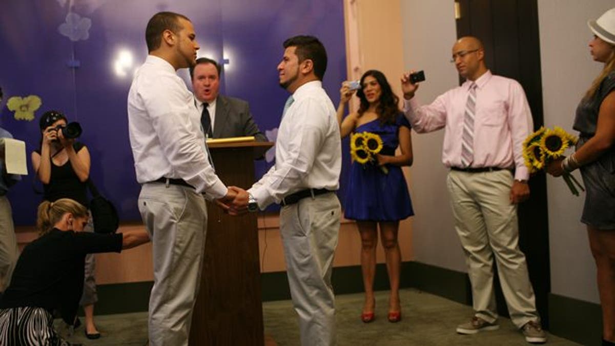 Marcos A. Chaljub, left, and Freddy L. Sambrano exchange vows at the Manhattan City Clerk's office on the first day New York State's Marriage Equality Act goes into effect, on Sunday, July 24, 2011, in New York. (AP Photo/Michael Appleton, Pool)