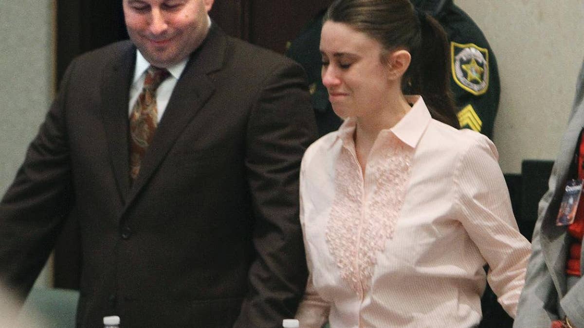 FILE - In this July 5, 2011, file photo, defense attorney Jose Baez, left, and Casey Anthony react after the jury acquitted her of murdering her daughter, Caylee, during Anthony's trial at the Orange County Courthouse in Orlando, Fla. Baez also won an acquittal for former New England Patriots tight end Aaron Hernandez in his 2017 double-murder trial. Baez said he feels driven to defend people accused of crimes because he believes they are sometimes treated harshly by the system and deserve a chance. (Red Huber/Orlando Sentinel via AP, Pool, File)