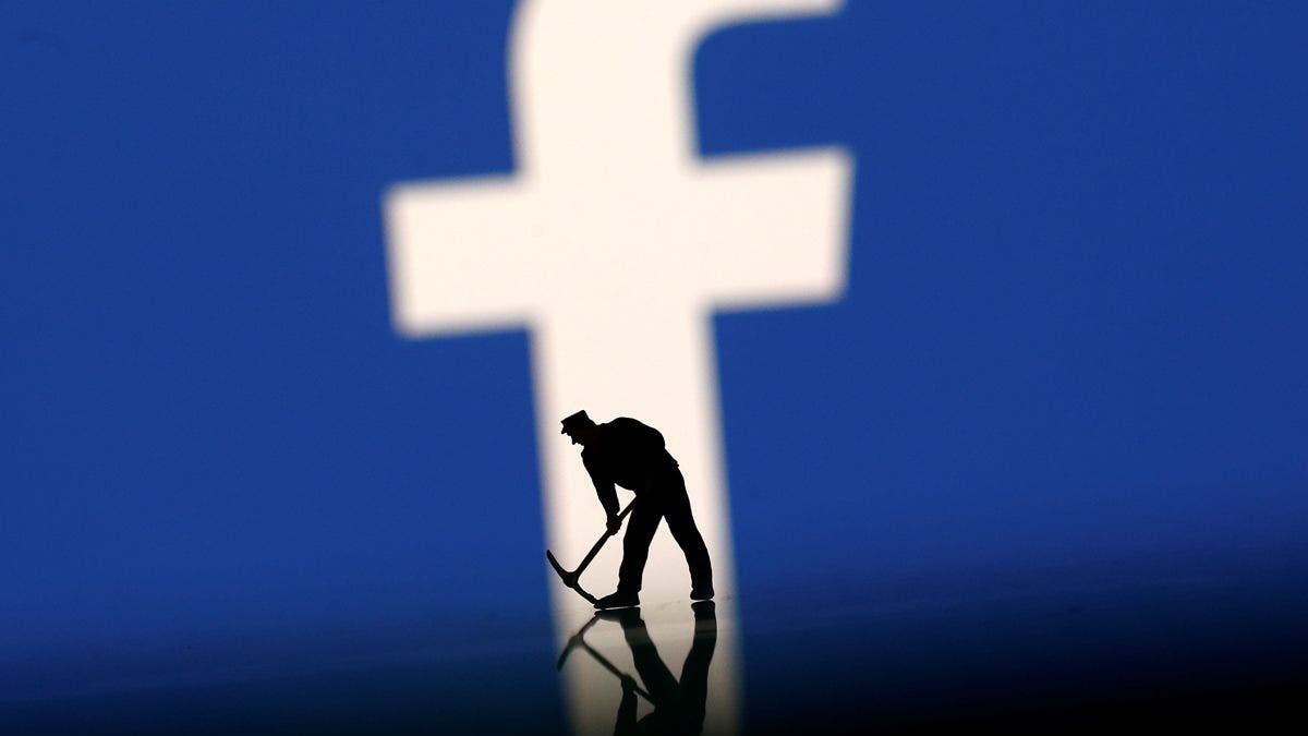 A figurine is seen in front of the Facebook logo in this illustration taken, March 20, 2018. REUTERS/Dado Ruvic - RC155C02C7D0