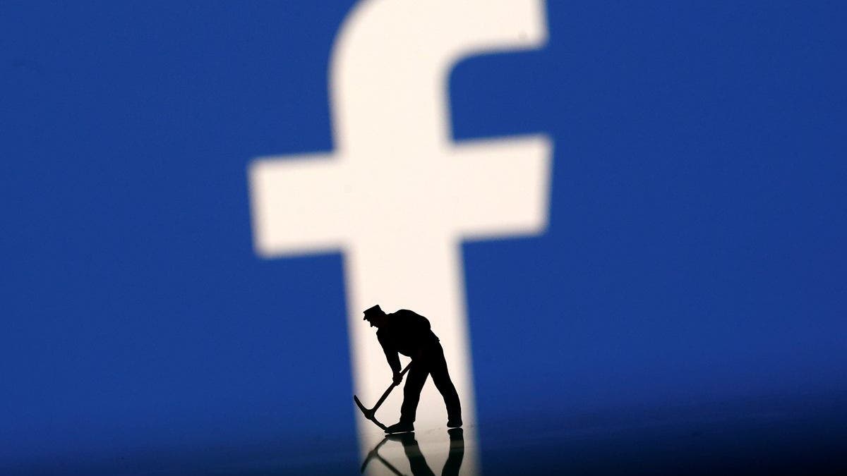 A figurine is seen in front of the Facebook logo in this illustration taken, March 20, 2018. REUTERS/Dado Ruvic - RC155C02C7D0