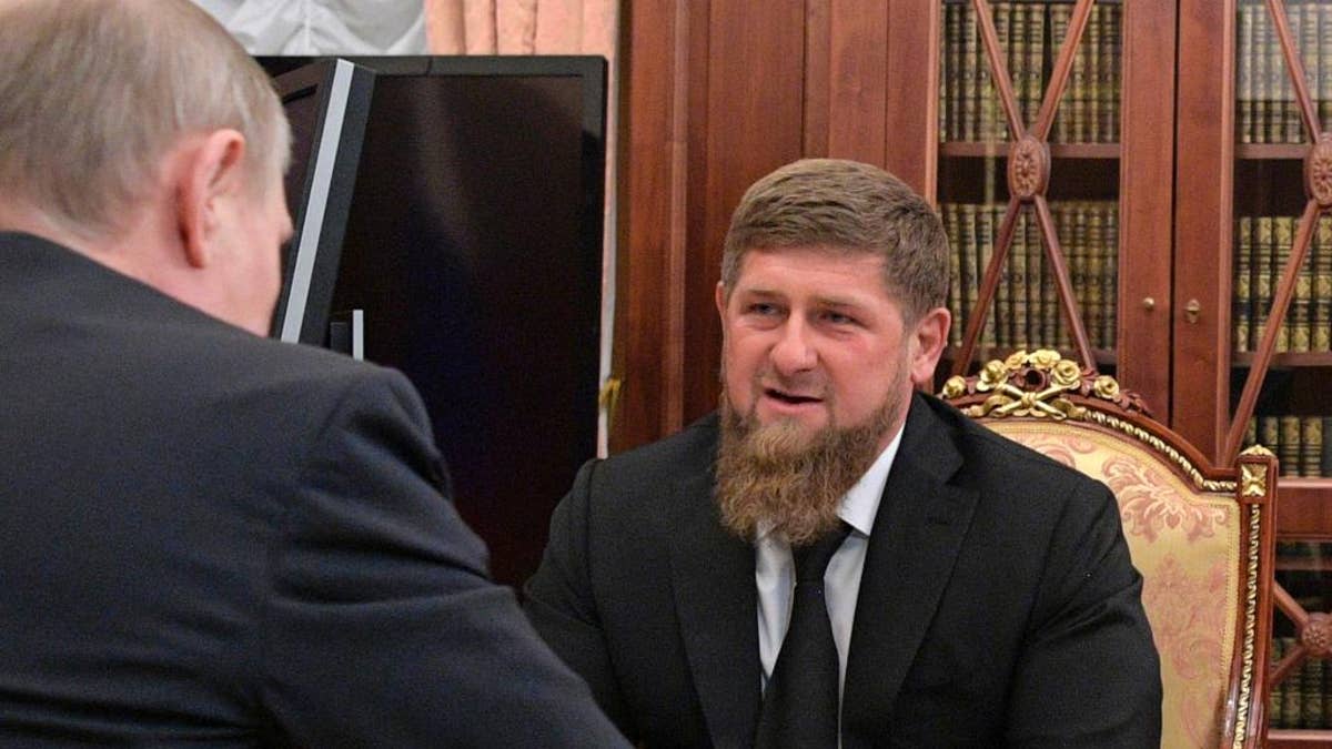 In this photo taken Wednesday, April 19, 2017, Russian President Vladimir Putin, left, meets with Chechnya's regional leader Ramzan Kadyrov in the Kremlin in Moscow, Russia. Putin met late Wednesday with Kadyrov, who told the president not to believe the "provocative" articles, reporting detentions and killings of gay men in Chechnya, which he says have no basis in fact. (Alexei Druzhinin/Sputnik, Kremlin Pool Photo via AP)