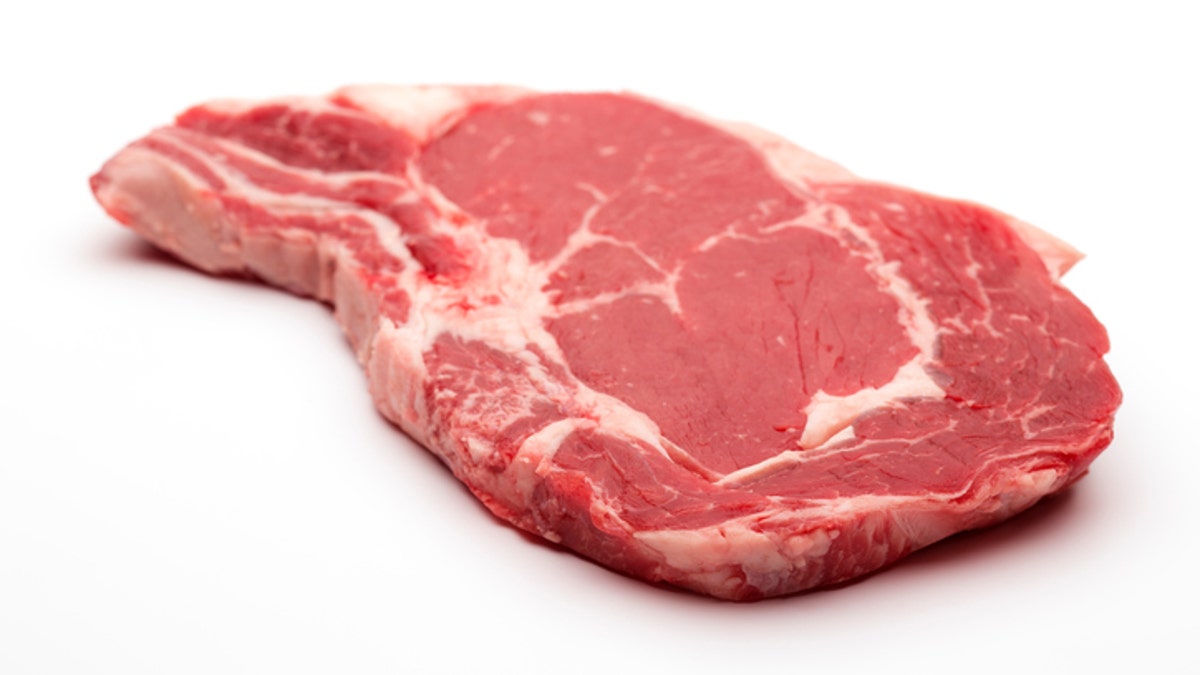Rib eye on the bone Steak beef meat raw on white