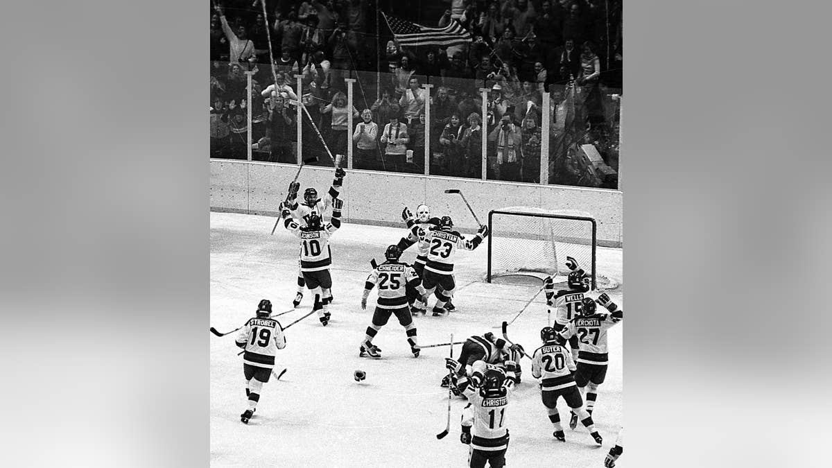 The United States ice hockey team rushes toward goalie Jim Craig after their 4-3 upset win over the Soviet Union in the semi-final round of the XIII Winter Olympic Games in Lake Placid, N.Y., Feb. 22, 1980. (Associated Press)