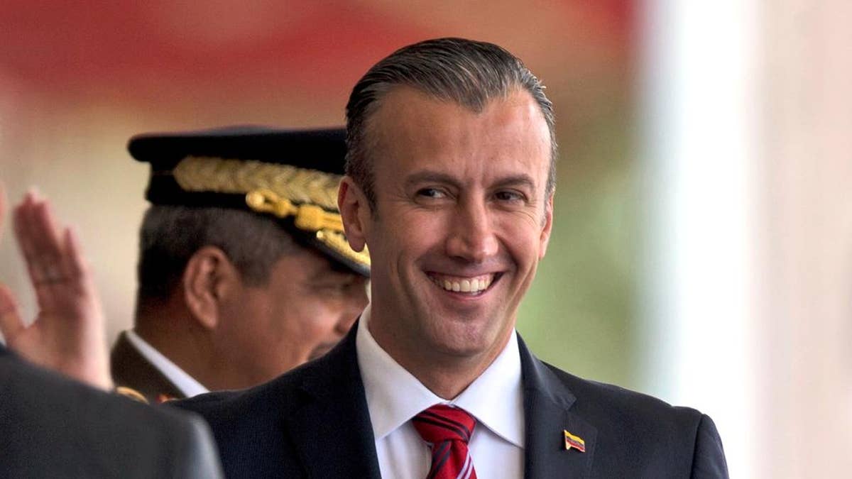 FILE - In this Feb. 1, 2017 photo, Venezuela's Vice President Tareck El Aissami, right, is saluted by Boilivarian Army officer upon his arrival for a military parade at Fort Tiuna in Caracas, Venezuela. The administration of President Donald Trump is slapping sanctions on El Aissami and accusing him of playing a major role in international drug trafficking. That’s according to individuals briefed on the U.S. government’s plans who requested anonymity to disclose the move ahead of a formal announcement. (AP Photo/Fernando Llano)