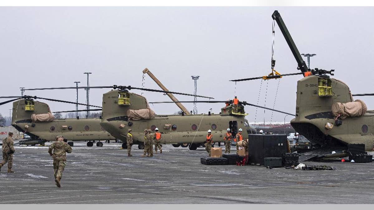U.S. Technicians prepare helicopters for the transport in Bremerhaven, northern Germany, Sunday Feb. 12, 2017. (Ingo Wagner/dpa via AP)