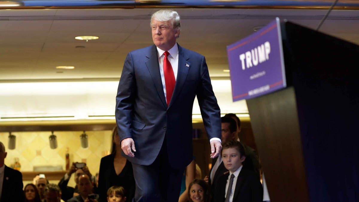 Developer Donald Trump takes the stage to announce that he will seek the Republican nomination for president, Tuesday, June 16, 2015, in the lobby of Trump Tower in New York, Tuesday, June 16, 2015. (AP Photo/Richard Drew)