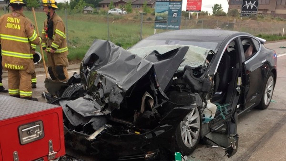 FILE -In this Friday, May 11, 2018, file photo released by the South Jordan Police Department shows a traffic collision involving a Tesla Model S sedan with a Fire Department mechanic truck stopped at a red light in South Jordan, Utah. The driver of a Tesla electric car that hit a Utah fire department vehicle over the weekend says the car's semi-autonomous Autopilot mode was engaged at the time of the crash. Police in the Salt Lake City suburb of South Jordan said Monday, May 14, 2018, the driver also said in an interview that she was looking at her phone before the accident. The 28-year-old woman broke her foot when her car hit a fire truck stopped at a red light while going 60 mph (97 kph). (South Jordan Police Department via AP, File)