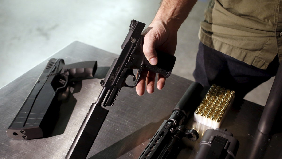 SilencerCo CEO Joshua Waldron shows guns with suppressors in West Valley City, Utah February 23, 2016. Gun silencers or suppressors, the accessory of Hollywood hit men, are becoming increasingly popular in the real world as hunters and other gun owners adopt them for hearing protection. REUTERS/Jim Urquhart - GF10000320628