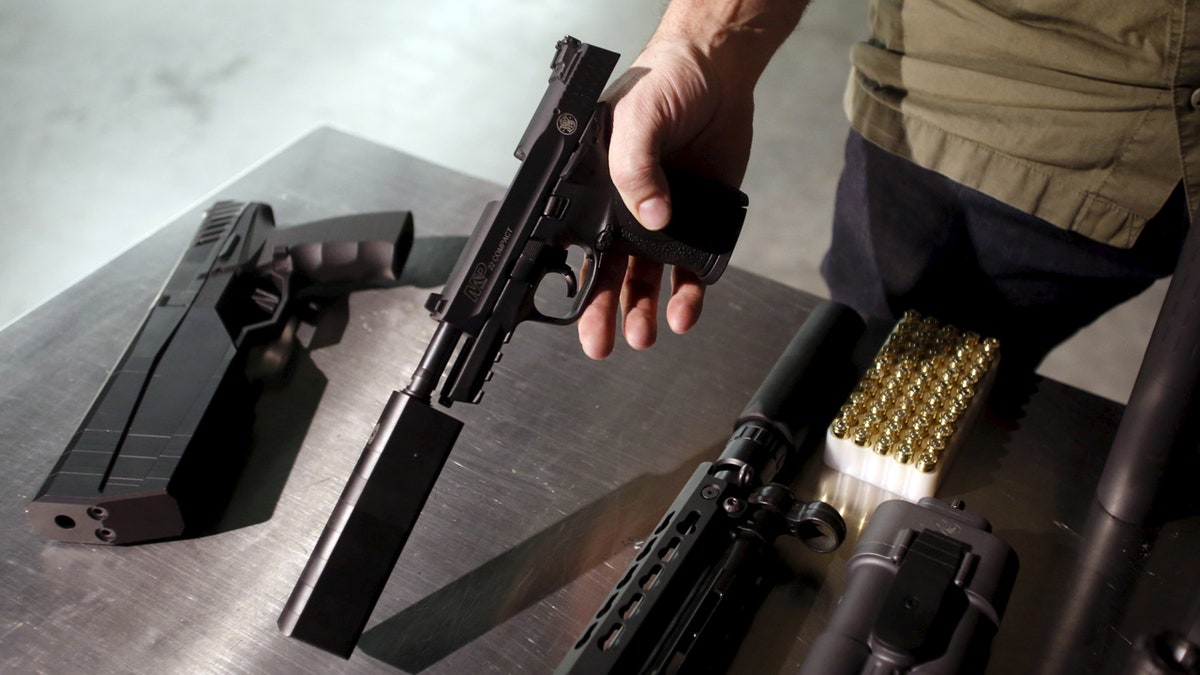 SilencerCo CEO Joshua Waldron shows guns with suppressors in West Valley City, Utah February 23, 2016. Gun silencers or suppressors, the accessory of Hollywood hit men, are becoming increasingly popular in the real world as hunters and other gun owners adopt them for hearing protection. REUTERS/Jim Urquhart - GF10000320628