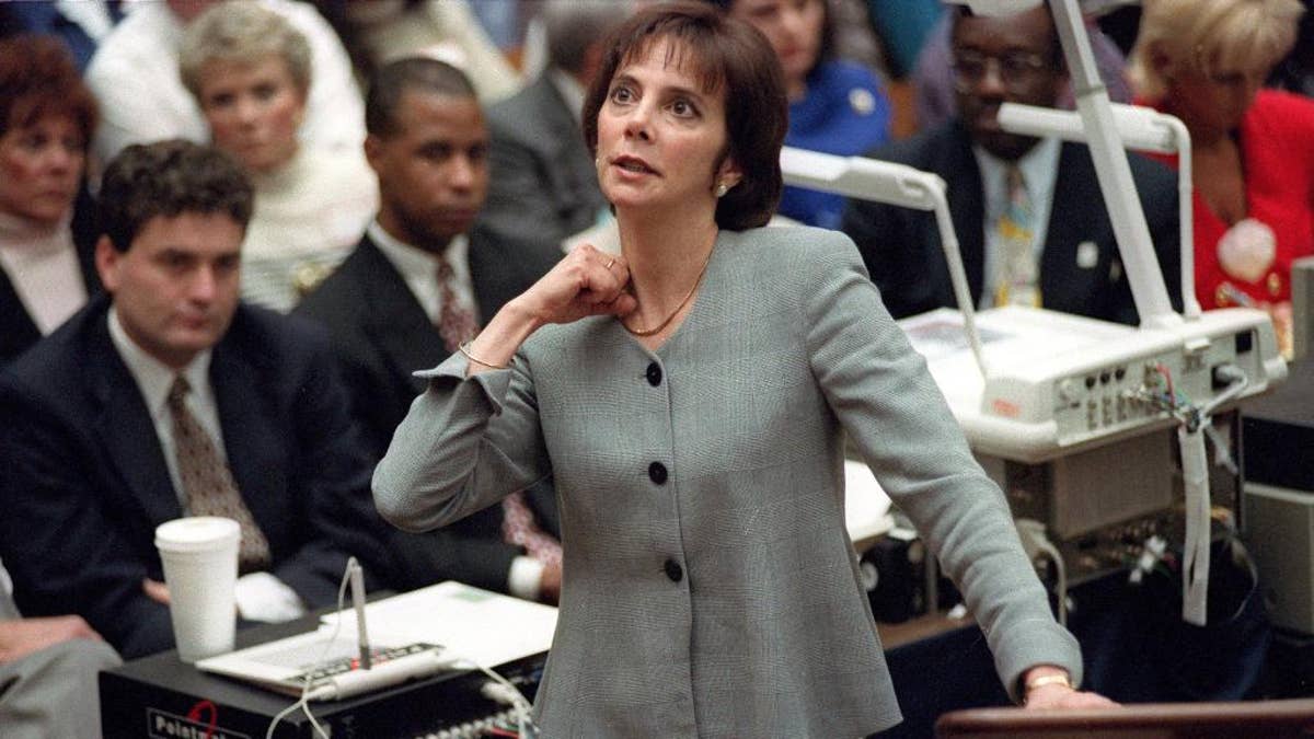FILE - In this Sept. 29, 1995 file photo, prosecutor Marcia Clark makes her closing arguments during the O.J. Simpson double-murder trial in Los Angeles, demonstrating on her own neck where a knife wound was sustained by murder victim Ronald Goldman. After nearly a month of testing, Los Angeles police detectives have concluded a knife found during demolition of the former Brentwood estate of O.J. Simpson was not the weapon used to kill Simpson's ex-wife Nicole Brown Simpson and her friend Ronald Goldman in 1994. Investigators ruled out the knife after weeks of forensic tests, Police Capt. Andy Neiman said Friday, April 1, 2016.(AP Photo/Reed Saxon, Pool, File)