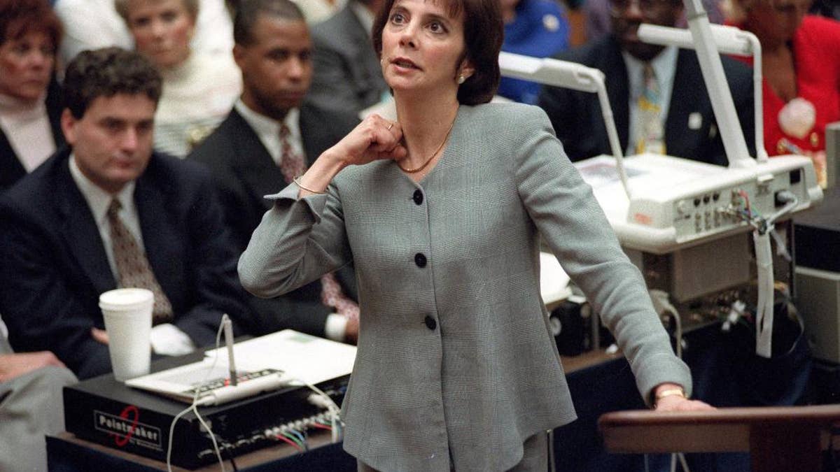 FILE - In this Sept. 29, 1995 file photo, prosecutor Marcia Clark makes her closing arguments during the O.J. Simpson double-murder trial in Los Angeles, demonstrating on her own neck where a knife wound was sustained by murder victim Ronald Goldman. After nearly a month of testing, Los Angeles police detectives have concluded a knife found during demolition of the former Brentwood estate of O.J. Simpson was not the weapon used to kill Simpson's ex-wife Nicole Brown Simpson and her friend Ronald Goldman in 1994. Investigators ruled out the knife after weeks of forensic tests, Police Capt. Andy Neiman said Friday, April 1, 2016.(AP Photo/Reed Saxon, Pool, File)