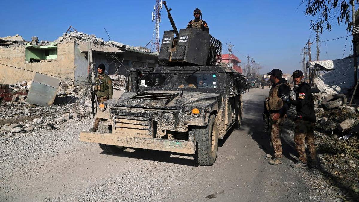 Iraq's elite counterterrorism forces inspect defenses after regaining control of the Quds neighborhood of Mosul, Iraq, Monday, Jan. 2, 2017. (AP Photo/ Khalid Mohammed)