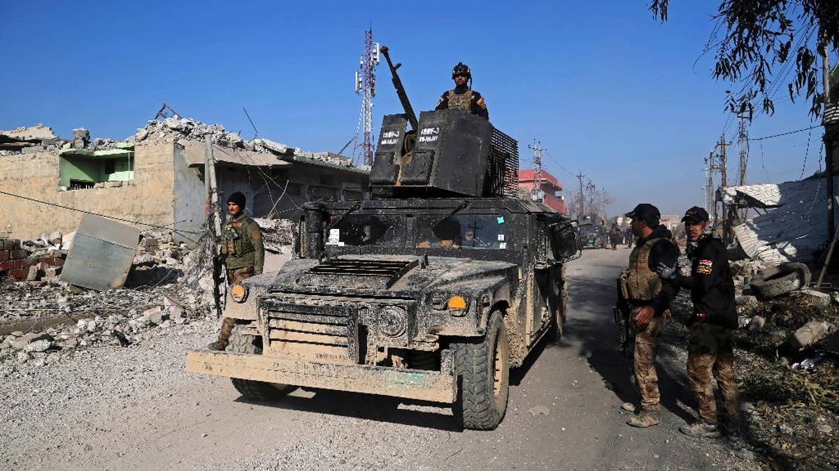 Iraq's elite counterterrorism forces inspect defenses after regaining control of the Quds neighborhood of Mosul, Iraq, Monday, Jan. 2, 2017. (AP Photo/ Khalid Mohammed)