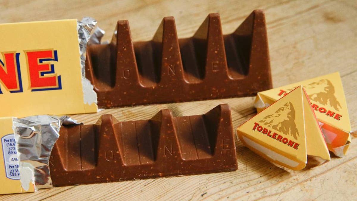 In this photo illustration two bars of the Toblerone Swiss chocolate are shown, at front is the new style 150 gram bar showing the reduction in triangular pieces, in the background is the older style 360 gram bar, pictured in London, Tuesday, Nov. 8, 2016. More valleys, fewer chocolate peaks: The maker of Toblerone Swiss chocolate says it's widened the spaces in its iconic, triangle-array bars for some discount shops in Britain to keep prices down. Mondelez International says the move aims to meet pricing targets by customer Poundland and other discount retailers, and has nothing to do with Britain's vote to leave the European Union. (AP Photo/Alastair Grant)