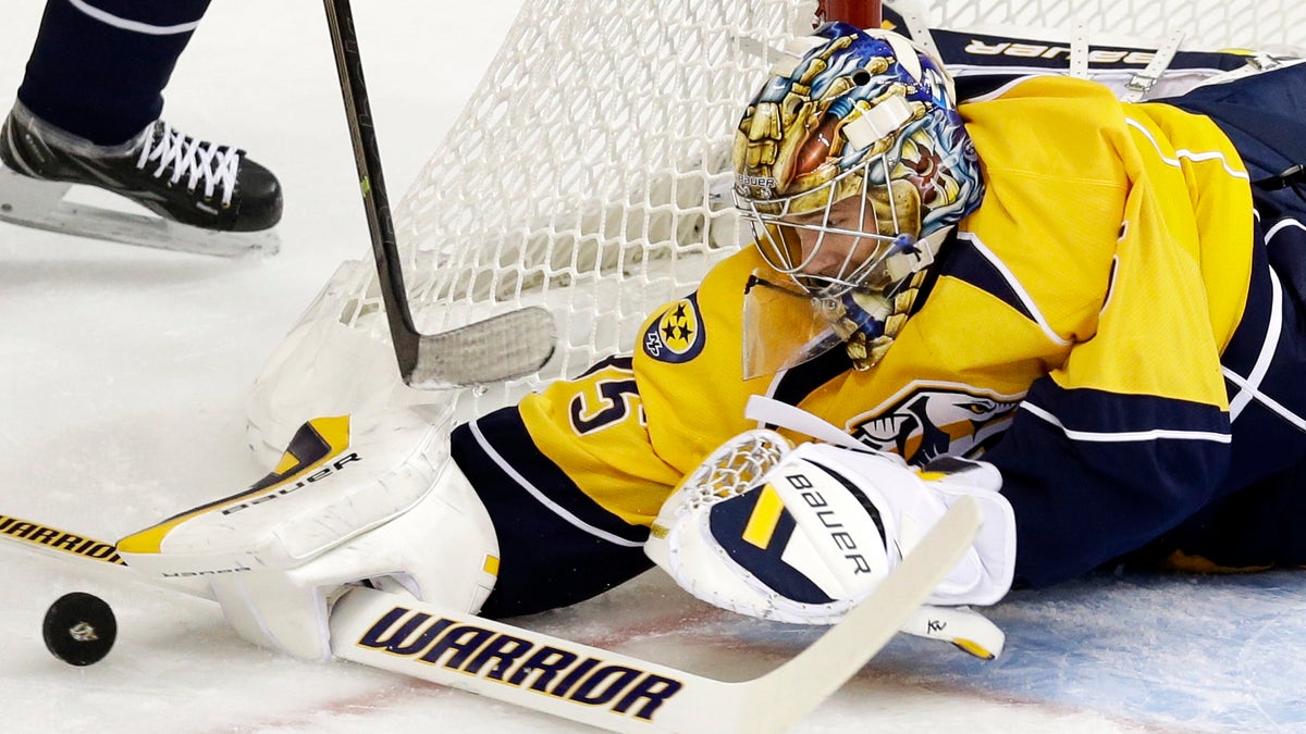 Nashville Predators goalie Pekka Rinne, of Finland, blocks a shot against the New York Islanders in the first period of an NHL hockey game on Saturday, Oct. 12, 2013, in Nashville, Tenn. (AP Photo/Mark Humphrey)