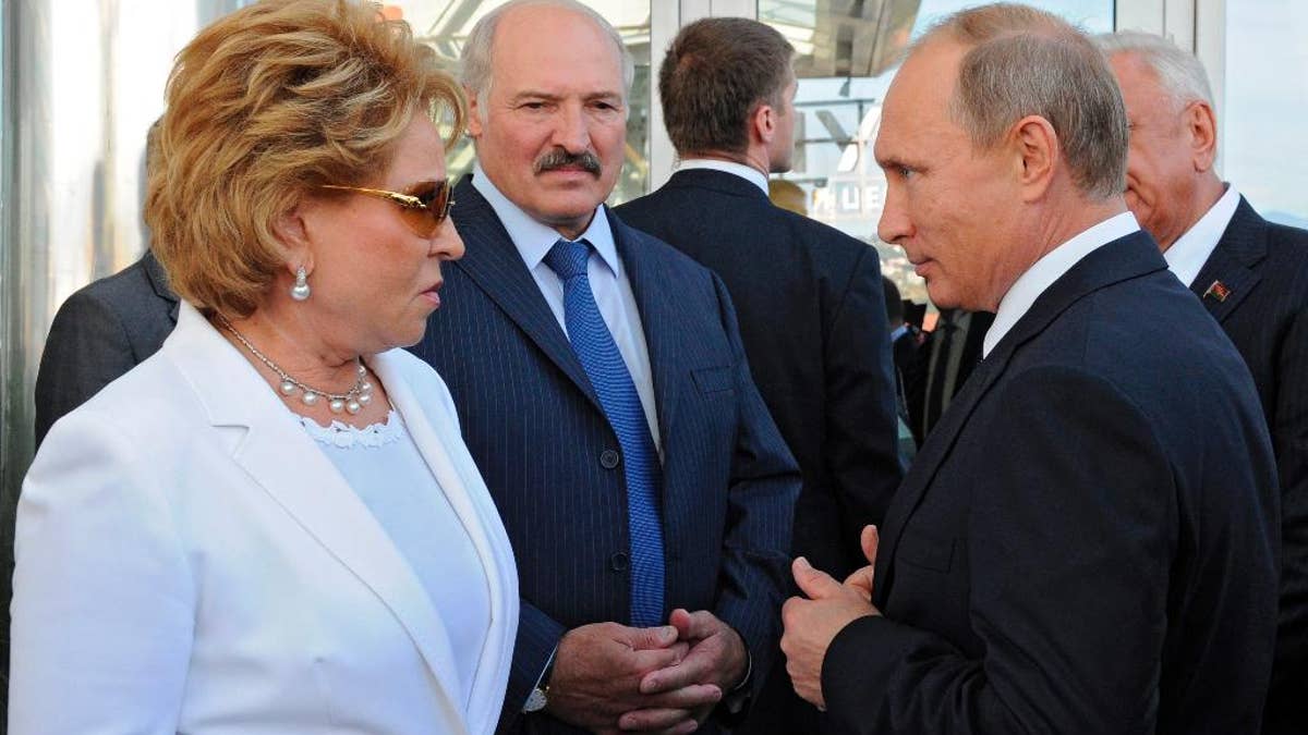 Russian President Vladimir Putin, right, Belarusian President Alexander Lukashenko, second left, and Upper House Speaker Valentina Matviyenko, left, visit the Sirius college for gifted children in the Black Sea resort of Sochi, Russia, Friday, Sept. 18, 2015. (Mikhail Klimentyev/RIA-Novosti, Kremlin Pool Photo via AP)