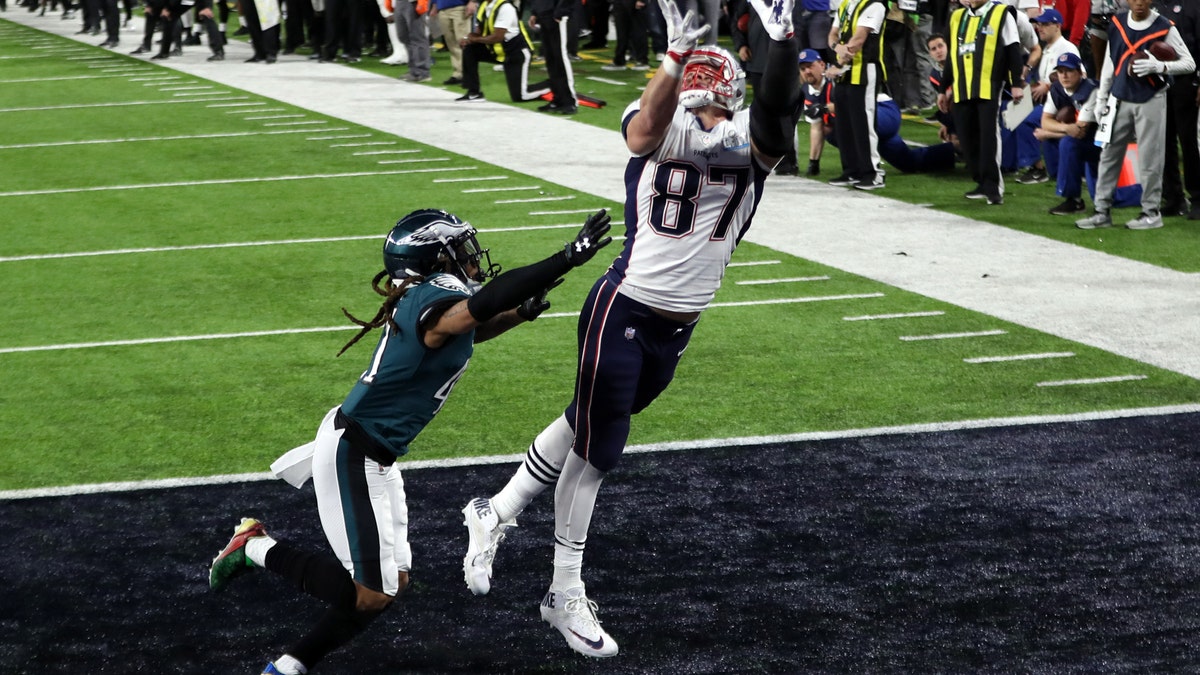 Feb 4, 2018; Minneapolis, MN, USA; New England Patriots tight end Rob Gronkowski (87) scores a touchdown over Philadelphia Eagles cornerback Ronald Darby (41) during the fourth quarter in Super Bowl LII at U.S. Bank Stadium. Mandatory Credit: Brace Hemmelgarn-USA TODAY Sports - 10588431