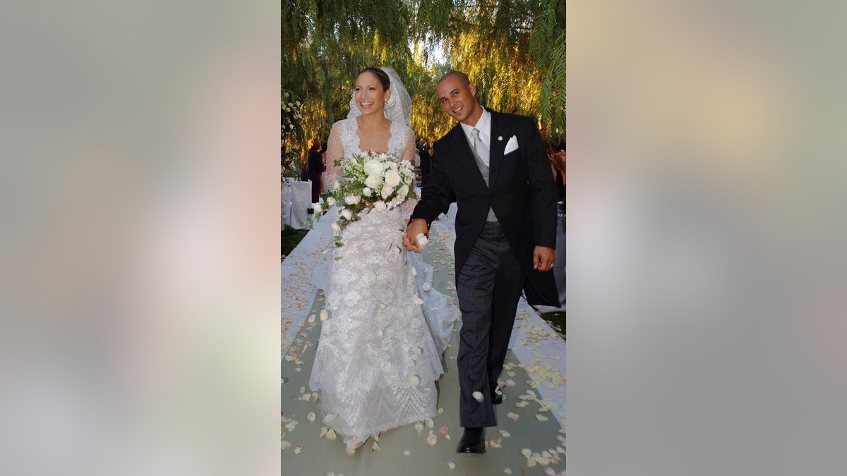 Actress and singer Jennifer Lopez, 31, holds hands with choreographer Cris Judd, 32, during their wedding ceremony, in Calabasas, Calif.