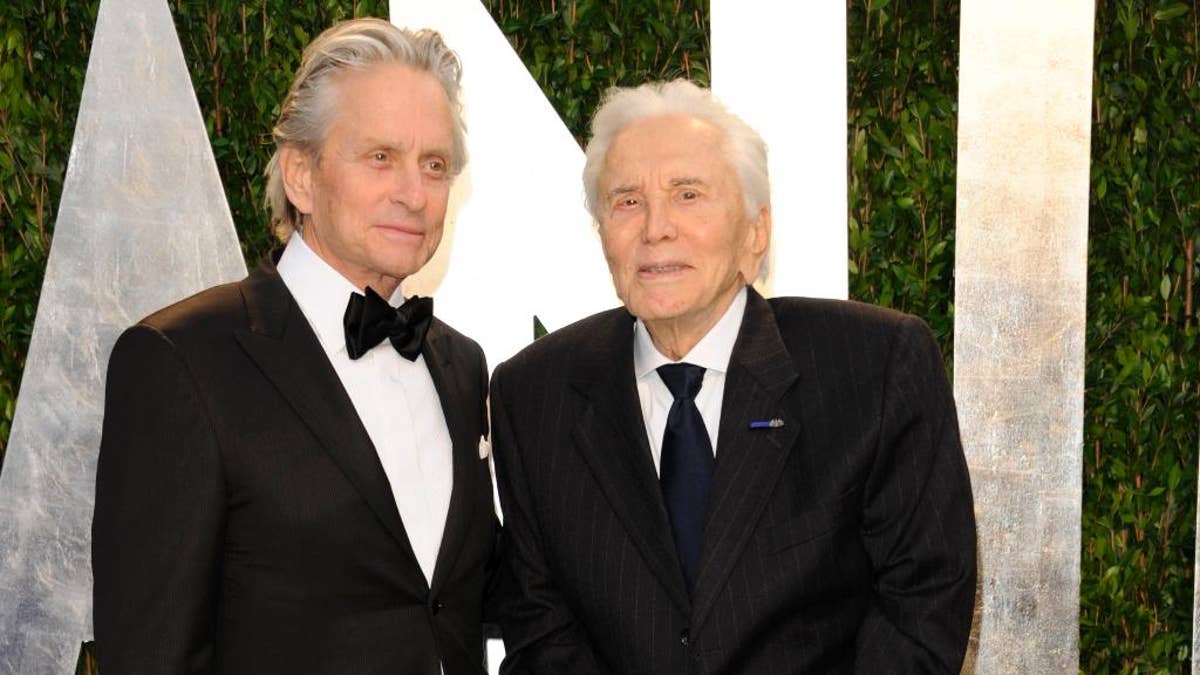 FILE - In this Feb. 26, 2012 file photo, Michael Douglas, left, and Kirk Douglas arrive at the Vanity Fair Oscar party in West Hollywood, Calif. Kirk Douglas has received an early 100th birthday present — an award from the World Jewish Congress for his strong support for Israel, including starring in the first Hollywood feature film shot in the newly established nation. Oscar-winning actor and producer Michael Douglas accepted the award at a dinner at the Pierre Hotel on Wednesday, Nov. 9, 2016, telling over 400 guests that his father will be 