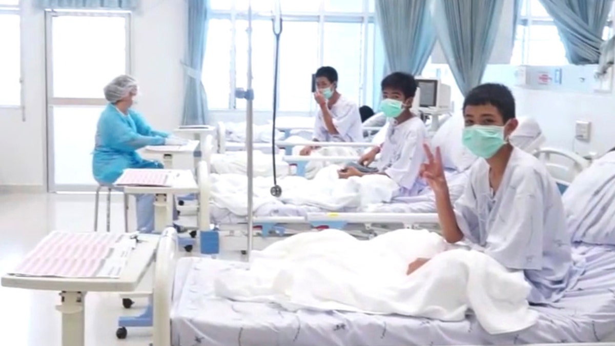 In this image made from video, released by the Thailand Government Spokesman Bureau, three of the 12 boys are seen recovering in their hospital beds after being rescued along with their coach from a flooded cave in Mae Sai, Chiang Rai province, northern Thailand. (Thailand Government Spokesman Bureau via AP)