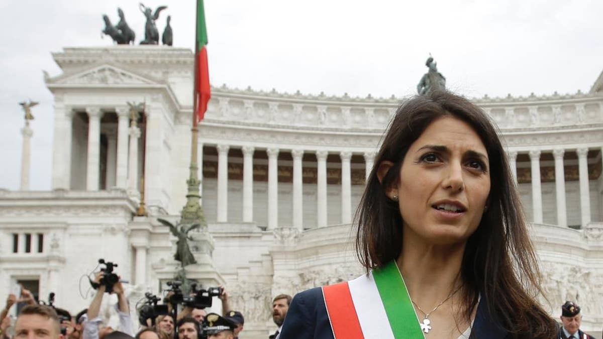 FILE - In this Thursday, June 23, 2016 filer, Rome's Mayor Virginia Raggi leaves the Rome's Vittoriano Unknown soldier monument after laying a wreath. Prosecutors are seeking to question Rome's embattled mayor over one of several problematic appointments that have tarnished her young administration and Italy's populist 5-Star Movement. In a Facebook post Tuesday, Jan. 24, 2017 Mayor Virginia Raggi confirmed the investigation, said she had "complete faith" in prosecutors and was prepared to provide them with all clarifications. (AP Photo/Gregorio Borgia, File)