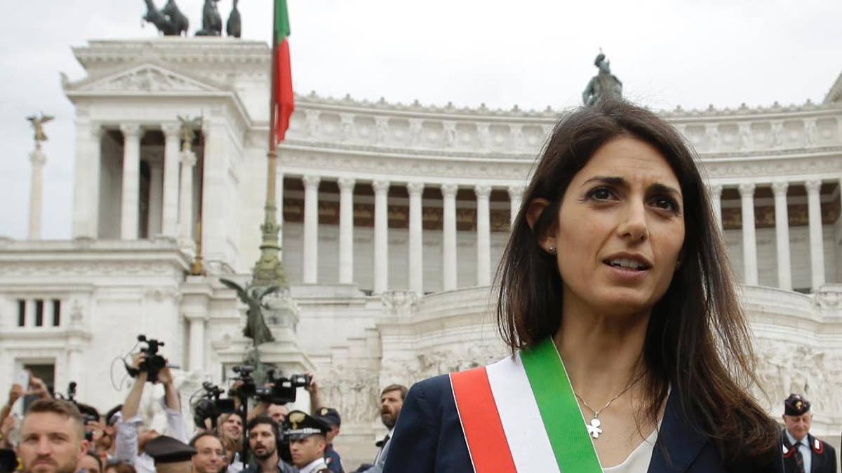 FILE - In this Thursday, June 23, 2016 filer, Rome's Mayor Virginia Raggi leaves the Rome's Vittoriano Unknown soldier monument after laying a wreath. Prosecutors are seeking to question Rome's embattled mayor over one of several problematic appointments that have tarnished her young administration and Italy's populist 5-Star Movement. In a Facebook post Tuesday, Jan. 24, 2017 Mayor Virginia Raggi confirmed the investigation, said she had "complete faith" in prosecutors and was prepared to provide them with all clarifications. (AP Photo/Gregorio Borgia, File)