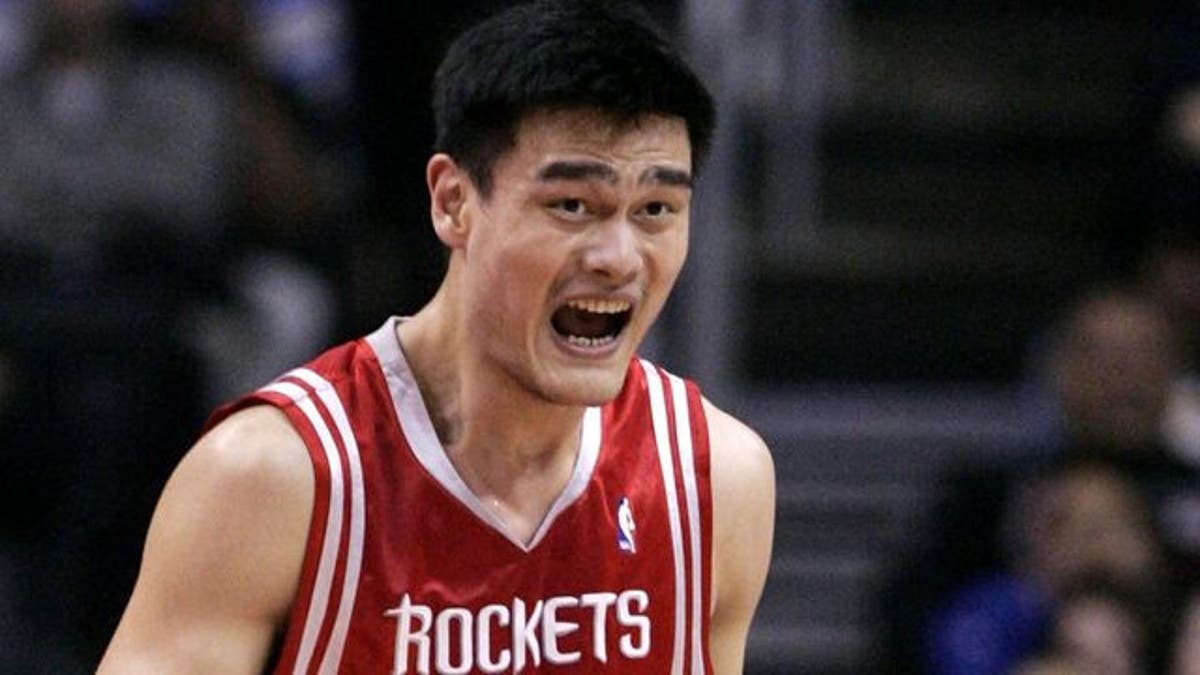 Houston Rockets' Yao Ming of China reacts during an NBA game in Los Angeles in this February 14, 2006 file photograph. China's NBA all-star Yao Ming has sued a Chinese sportswear maker over alleged name and image infringements, local media reported on May 13, 2011. The towering Houston Rockets centre has filed a lawsuit against the company for using the label "Yao Ming Era" on its shoes without his consent, Yao's management said. REUTERS/Lucy Nicholson/Files (UNITED STATES - Tags: SPORT BASKETBALL)