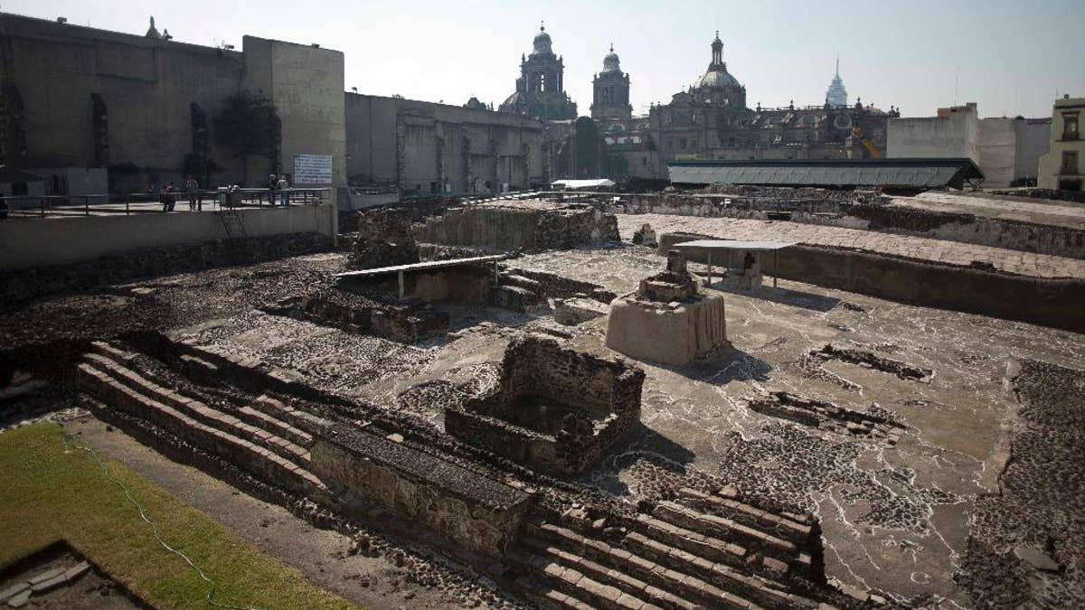 Tourists visit the Templo Mayor archaeological site in Mexico City, Tuesday Dec. 1, 2015. Mexican archaeologists have discovered, at the archaeological site, a long tunnel leading into the center of a circular platform where Aztec rulers were believed to be cremated. The Aztecs are believed to have cremated the remains of their leaders during their 1325-1521 rule, but the final resting place of the cremains has never been found. (AP Photo/Eduardo Verdugo)