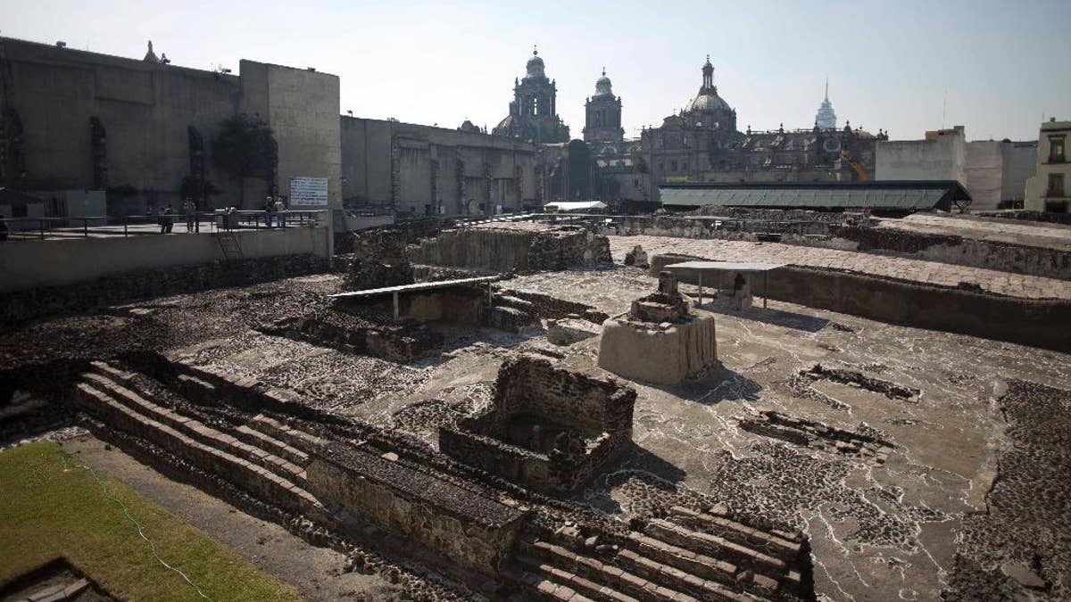 Tourists visit the Templo Mayor archaeological site in Mexico City, Tuesday Dec. 1, 2015. Mexican archaeologists have discovered, at the archaeological site, a long tunnel leading into the center of a circular platform where Aztec rulers were believed to be cremated. The Aztecs are believed to have cremated the remains of their leaders during their 1325-1521 rule, but the final resting place of the cremains has never been found. (AP Photo/Eduardo Verdugo)