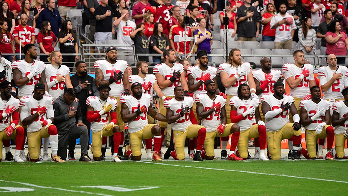 Oct 1, 2017; Glendale, AZ, USA; Members of the San Francisco 49ers kneel during the National Anthem prior to a game against the Arizona Cardinals at University of Phoenix Stadium. Mandatory Credit: Matt Kartozian-USA TODAY Sports - 10321251