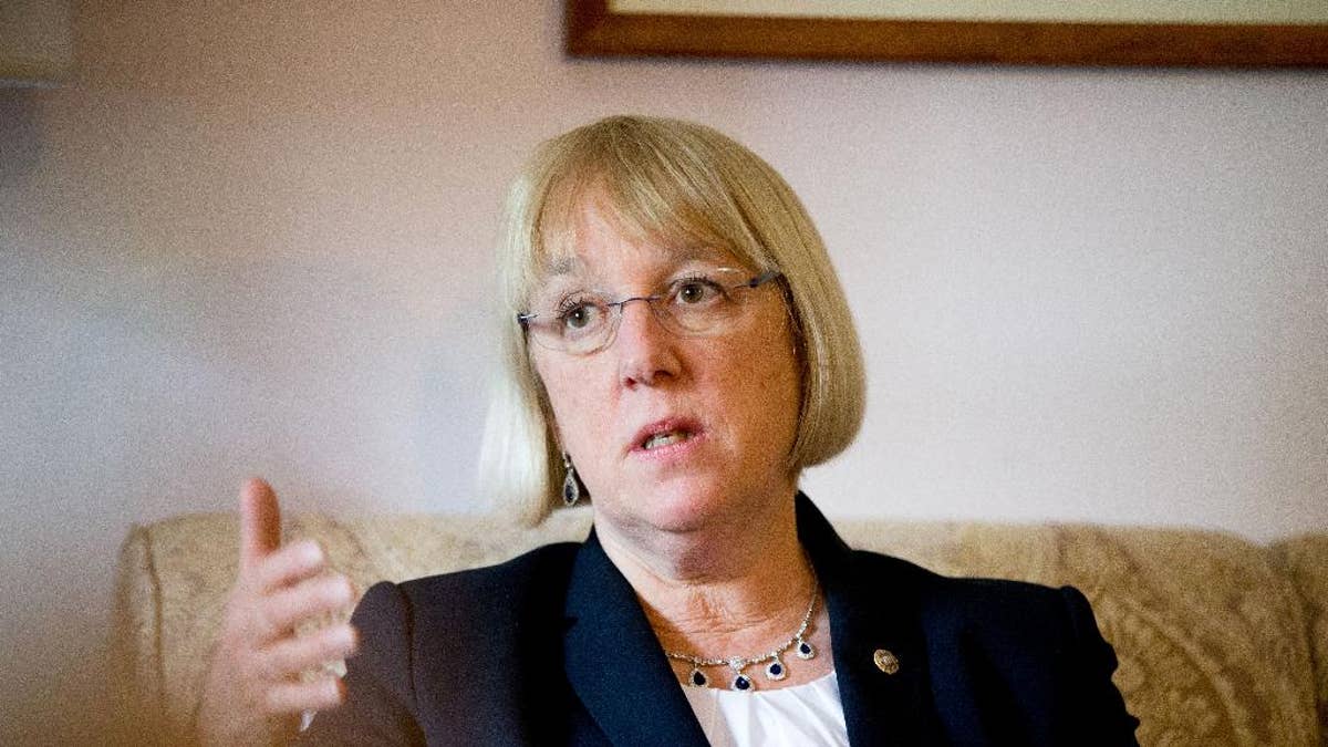 Patty Murray, in a white shirt and black suit jacket, gestures