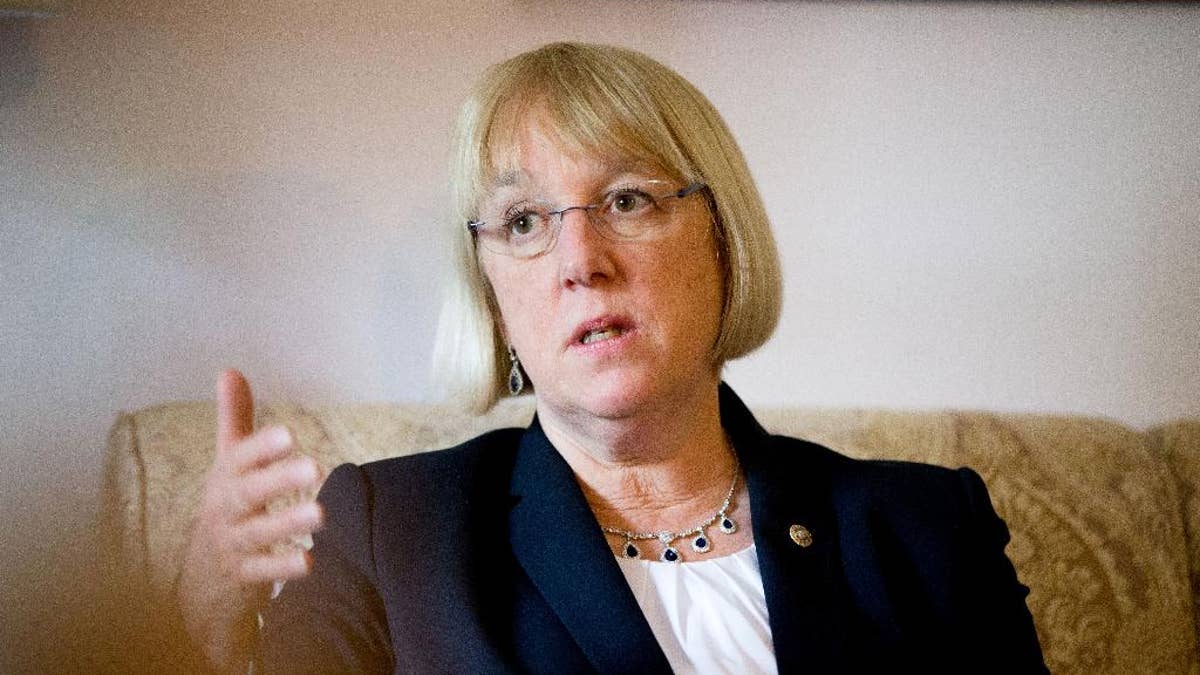 Patty Murray, in a white shirt and black suit jacket, gestures