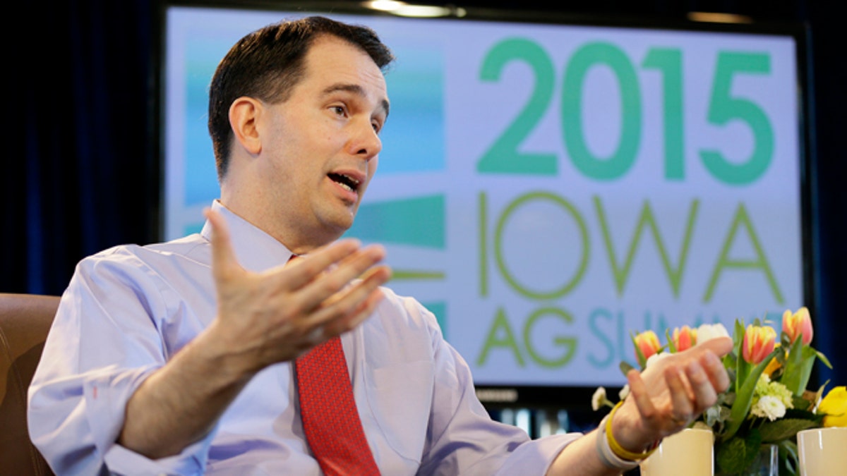 FILE - In this March 7, 2015 file photo, Wisconsin Gov. Scott Walker speaks during the Iowa Agriculture Summit in Des Moines, Iowa. Known for his accessibility and willingness to always be available to take questions, even after the most routine appearances, Walker has suddenly become much harder to reach as he ramps up for a likely 2016 presidential campaign and deals with a series of flubs and shifts in position on hot button issues. (AP Photo/Charlie Neibergall)