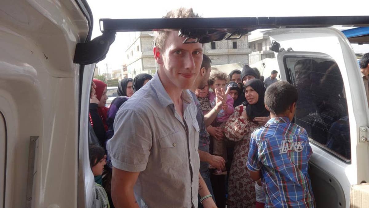 This undated photo provided by the Kassig family shows Peter Kassig delivering supplies for Syrian refugees.