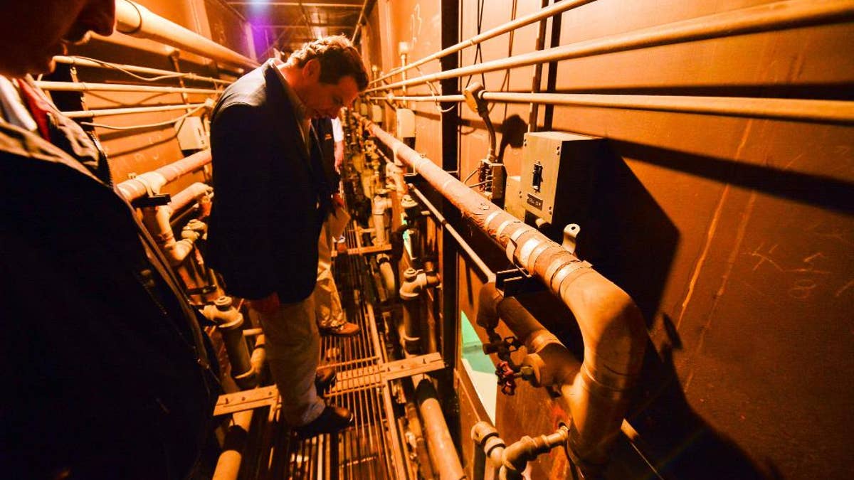 This photo provided by New York State Governor's office shows Gov. Andrew Cuomo on a catwalk looking into the cell that inmates escaped from at a maximum-security prison near the Canadian border in Dannemora, NY.  Gov. Cuomo said Saturday, June 6, 2015, that Richard Matt, 48, and David Sweat, 34, 