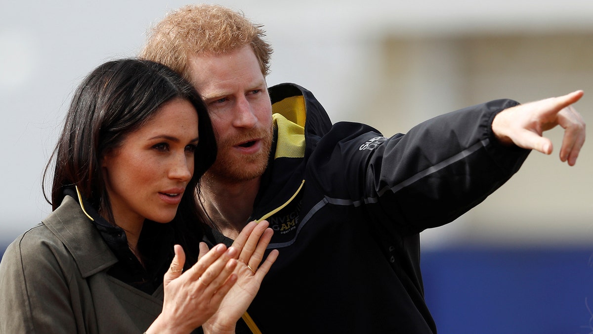 Britain's Prince Harry, Patron of the Invictus Games Foundation, and Meghan Markle watch athletes at the team trials for the Invictus Games Sydney 2018 at the University of Bath Sports Training Village in Bath, Britain, April 6, 2018. REUTERS/Peter Nicholls - RC1A1D29ABF0