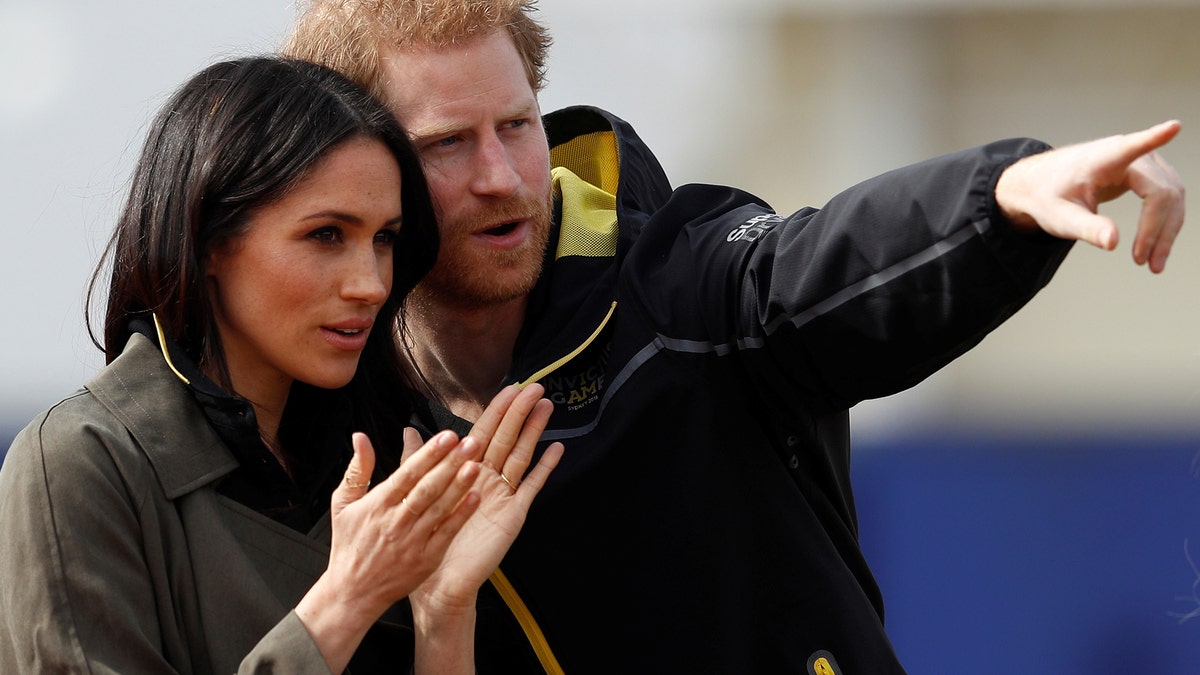 Britain's Prince Harry, Patron of the Invictus Games Foundation, and Meghan Markle watch athletes at the team trials for the Invictus Games Sydney 2018 at the University of Bath Sports Training Village in Bath, Britain, April 6, 2018. REUTERS/Peter Nicholls - RC1A1D29ABF0