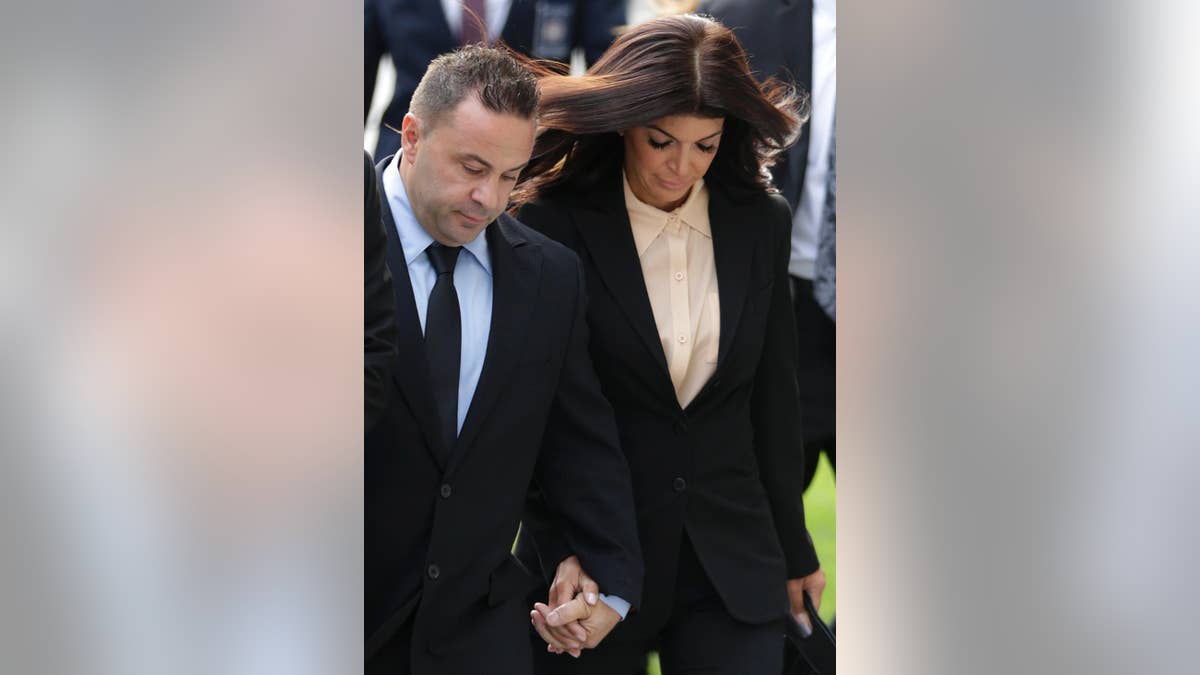 FILE- In this Oct. 2, 2014 file photo, "The Real Housewives of New Jersey" stars Teresa Giudice, and her husband Giuseppe "Joe" Giudice, left, of Montville Township, N.J., walk toward Martin Luther King Jr. Courthouse for a court appearance on federal conspiracy and bankruptcy fraud charges in Newark, N.J. An attorney for Joe Giudice said the husband of Teresa Giudice, is expected to report to the Fort Dix federal prison on Wednesday, March 23, 2016, to begin serving a 41-month sentence for bankruptcy fraud. (AP Photo/Julio Cortez, File)