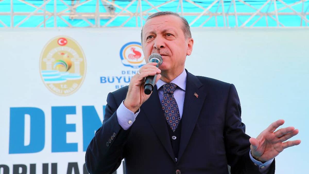 Turkey's President Recep Tayyip Erdogan addresses his supporters in Denizli, Turkey, Friday, March 24, 2017. Erdogan has hit out at the head of Germany's intelligence service for comments suggesting that Berlin was not convinced over U.S.-based cleric Fethullah Gulen's role in Turkey's failed coup. (Kayhan Ozer/Presidential Press Service, Pool Photo via AP)