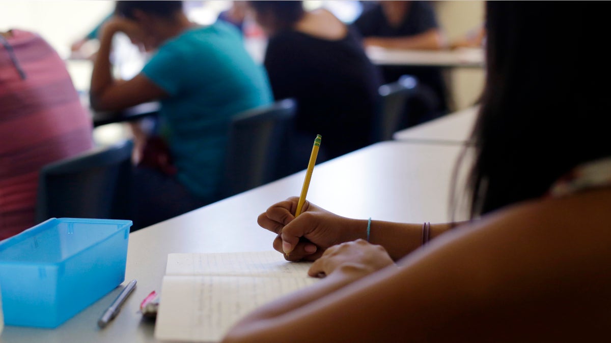 In this Wednesday, Sept. 10, 2014 photo, math is taught to high school students during a class at the Karnes County Residential Center, a temporary home for immigrant women and children detained at the border, in Karnes City, Texas. (AP Photo/Eric Gay)