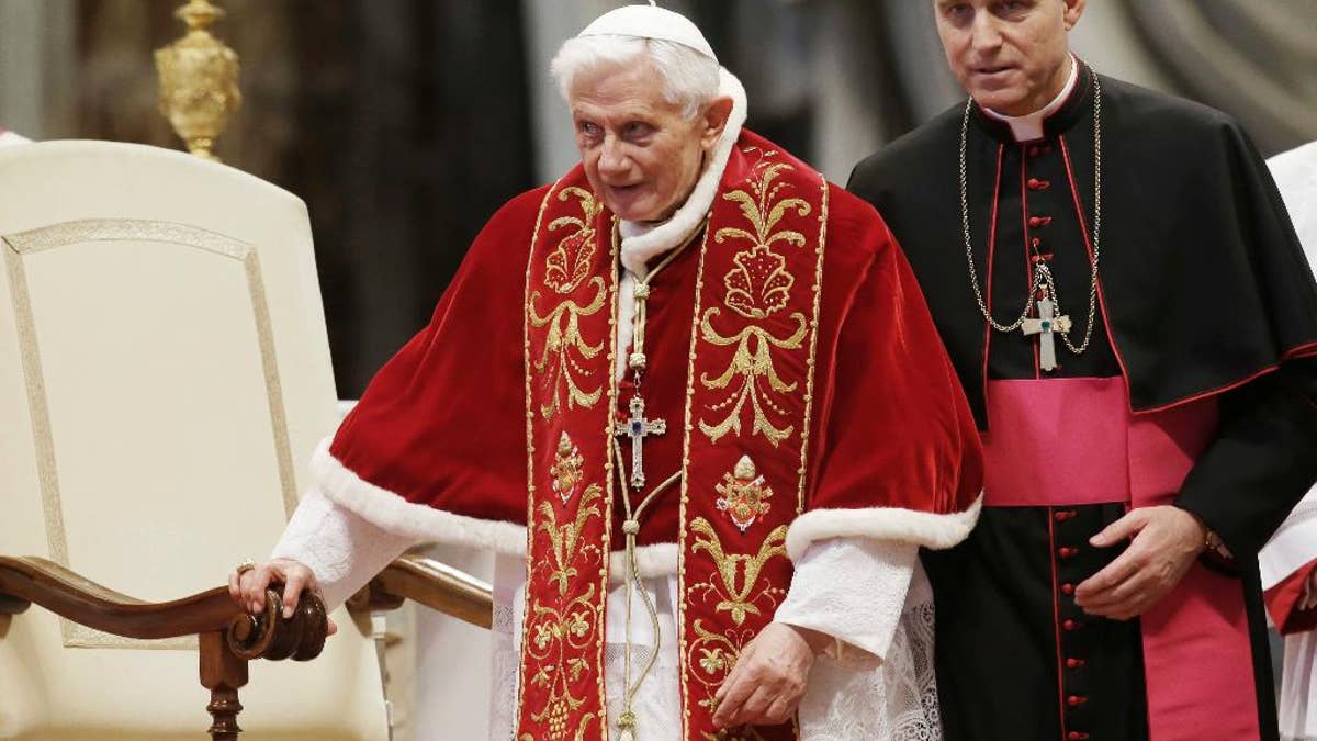 FILE - This Feb. 9, 2013 file photo shows Pope Benedict XVI flanked by personal secretary Archbishop Georg Gaenswein during a Mass to mark the 900th anniversary of the Order of the Knights of Malta in St. Peter's Basilica at the Vatican. Monsignor Georg Gaenswein, Benedict's personal aide, in comments published Sunday, Oct. 2, 2016, in Corriere della Sera, said a doctor told Benedict to stop taking trans-Atlantic flights. (AP Photo/Gregorio Borgia, files)