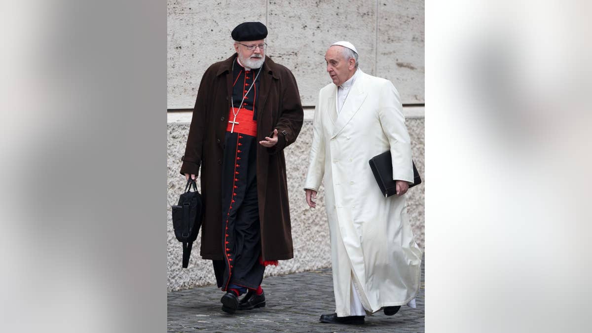 FILE - In this Feb. 13, 2015 file photo, Pope Francis, right, talks with the head of a sex abuse advisory commission, Cardinal Sean Patrick O'Malley, of Boston, as they arrive for a special consistory in the Synod hall at the Vatican. Pope Francis has quietly reduced sanctions against a few pedophile priests, applying his vision of a merciful church even to its worst offenders in ways that abuse survivors and the pope's own advisers question. (AP Photo/Andrew Medichini, File)