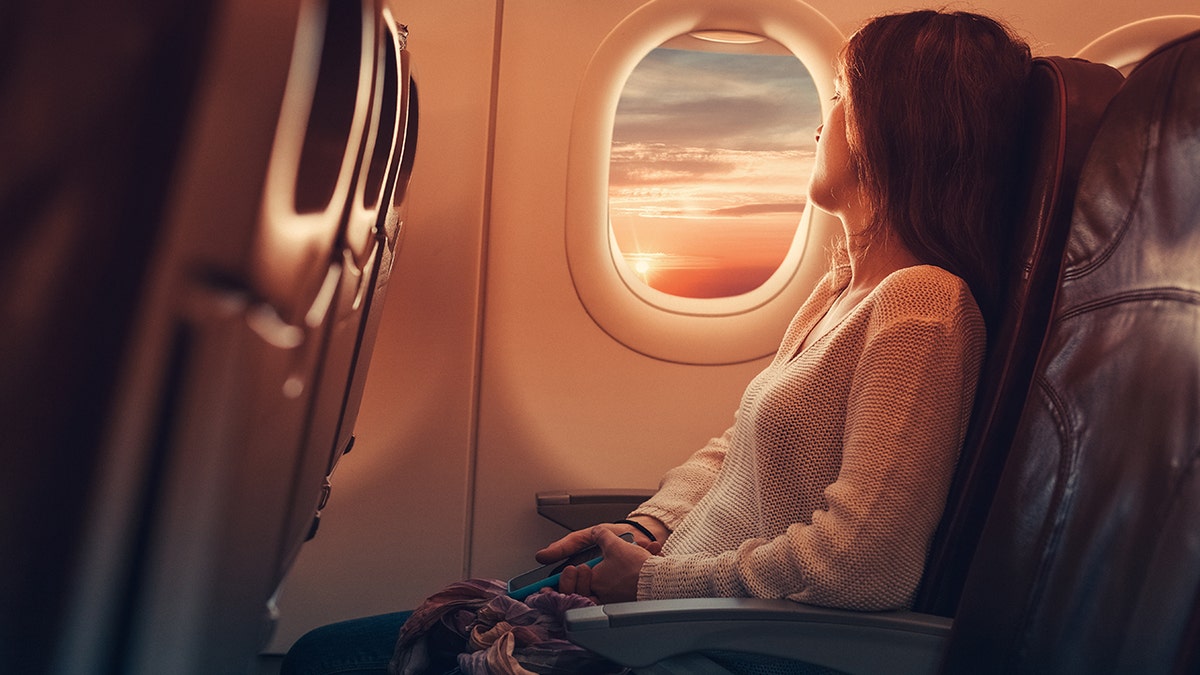 woman on plane istock