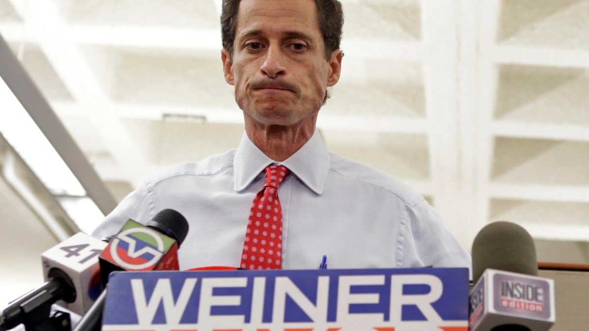 New York City Mayoral candidate Anthony Weiner grimaces during a news conference at the Gay Men's Health Crisis headquarters, Tuesday, July 23, 2013, in New York. The former congressman says he's not dropping out of the New York City mayoral race in light of newly revealed explicit online correspondence with a young woman. (AP Photo/Kathy Willens)