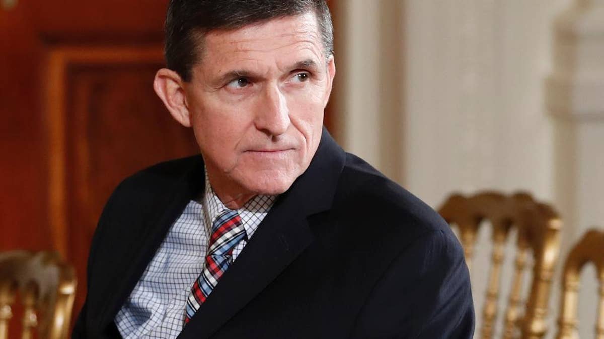FILE - In this Feb. 10, 2017 file photo, then-National Security Adviser Michael Flynn sits in the East Room of the White House in Washington. Former CIA Director James Woolsey has accused former Trump administration National Security Adviser Michael Flynn of participating in a discussion with Turkish officials in which the possibility of subverting the U.S. extradition process to remove a Turkish cleric from the U.S. The Wall Street Journal first reported Woolsey’s comments and posted a video interview with him late Friday. A Flynn spokesman said Friday that Woolsey’s claims were “false” and that “no such discussion occurred.” (AP Photo/Carolyn Kaster, File)