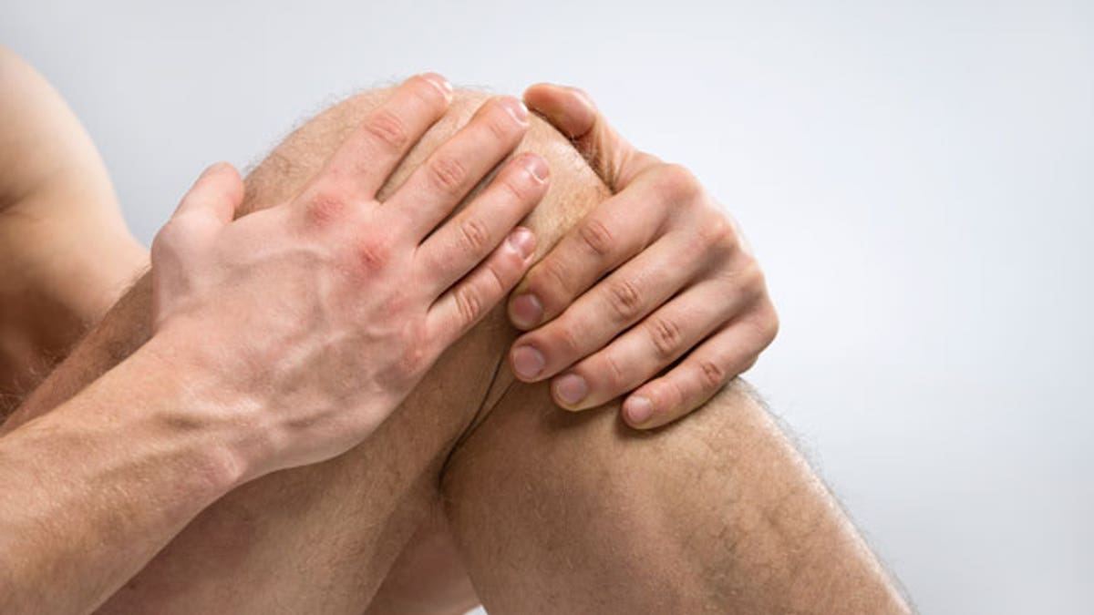 60373c54-Knee Pain. Man suffering from knee pain.